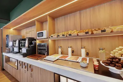 a bakery with a counter with bread and pastries at B&B HOTEL Santiago Milladoiro in Milladoiro