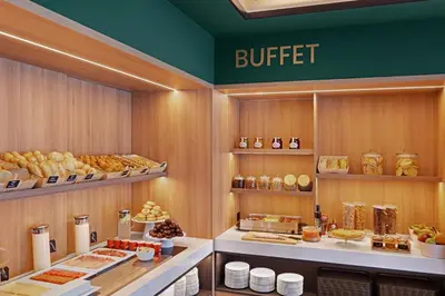 a buffet line with bread and other food on display at B&B HOTEL Santiago Milladoiro in Milladoiro