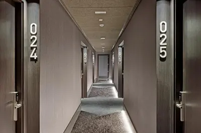 a corridor in a building with a long hallway at B&B HOTEL Santiago Milladoiro in Milladoiro
