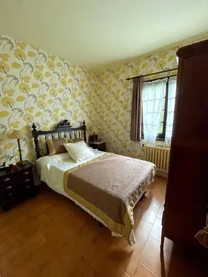 a bedroom with a bed with yellow wallpaper at As Erdades in Ourense