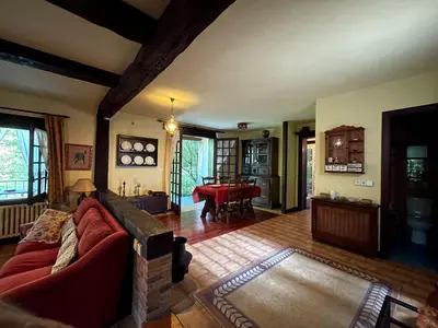 a living room with a red couch and a table at As Erdades in Ourense