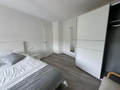 a white bedroom with a bed and a closet at Oktheway Caldas Centro in Caldas de Reis