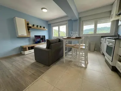 a kitchen with a couch and a table in a room at Oktheway Caldas Centro in Caldas de Reis