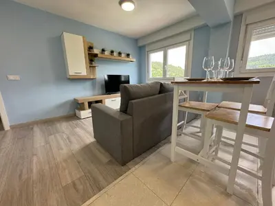 a living room with a couch and a table at Oktheway Caldas Centro in Caldas de Reis