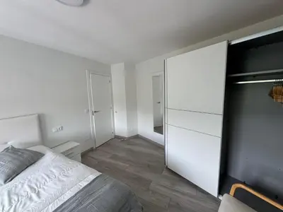 a bedroom with a bed and a white closet at Oktheway Caldas Centro in Caldas de Reis