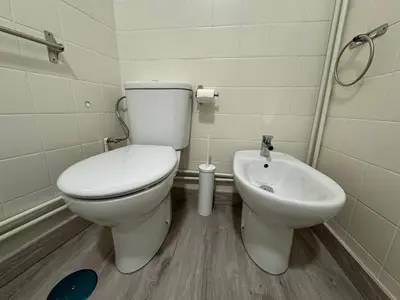 a bathroom with a toilet and a sink at Oktheway Caldas Centro in Caldas de Reis