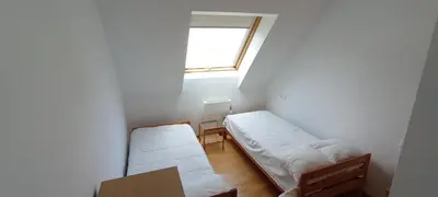 a small room with two beds and a window at EnBURELA Confort y Relax in Burela de Cabo