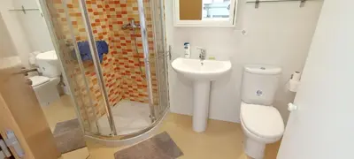 a bathroom with a shower and a toilet and a sink at EnBURELA Confort y Relax in Burela de Cabo