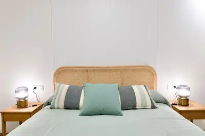 a bedroom with a bed with two lamps on two tables at Rosalia Park by Lugo Collection in Lugo