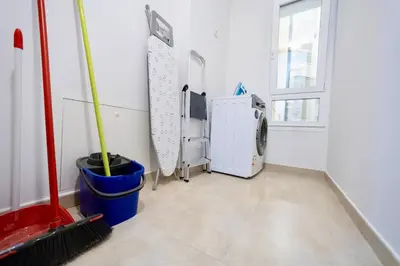 a laundry room with a washing machine and a window at Rosalia Park by Lugo Collection in Lugo