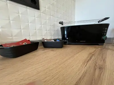 a microwave sitting on top of a wooden floor at Apartamento BURELA PALOMA PLAYA in Burela de Cabo