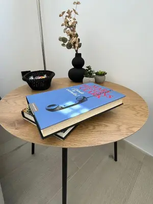 a table with a book and a pen on it at Apartamento BURELA PALOMA PLAYA in Burela de Cabo