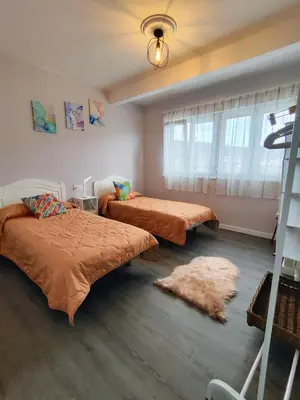 a bedroom with a large bed with a green headboard at Piso en el centro de Viveiro in Viveiro