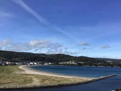 a park bench sitting on a hill overlooking a lake at Piso en el centro de Viveiro in Viveiro