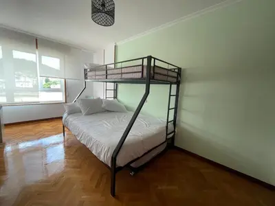 a bedroom with a bunk bed in a room at Covas Home in Viveiro