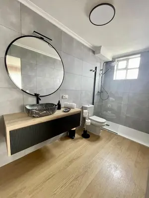 a bathroom with a sink and a mirror and a toilet at Covas Home in Viveiro