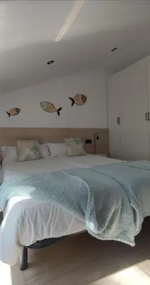 a bedroom with a large bed with fishes on the wall at BURELA Mariña PLAYA in Burela de Cabo