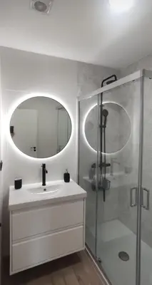 a bathroom with a sink and a shower with a mirror at BURELA Mariña PLAYA in Burela de Cabo