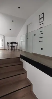 a staircase in a house with a glass wall at BURELA Mariña PLAYA in Burela de Cabo