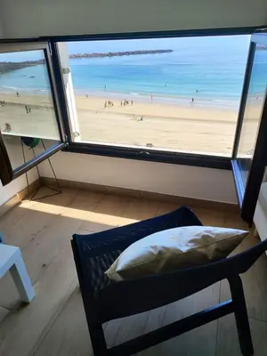 a room with a window with a view of a beach at BURELA Mariña PLAYA in Burela de Cabo