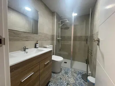 a bathroom with a toilet and a sink and a shower at Céntrico apartamento muralla 2 in Lugo
