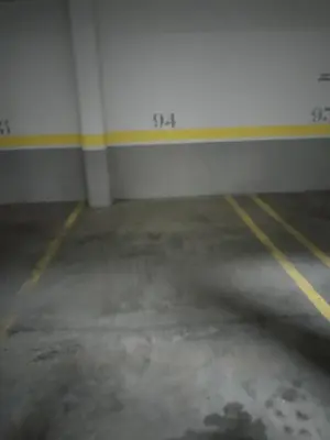 an empty parking garage with a white wall at Viveiro Centro con parking in Viveiro