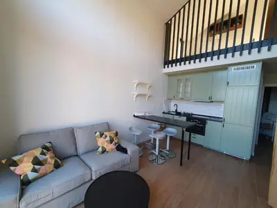 a living room with a couch and a kitchen at Apartamentos Islas Pantorgas in Tapia de Casariego