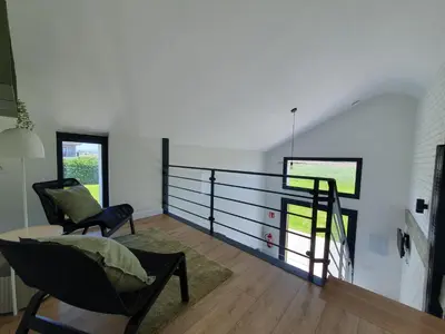 a living room with a table and a chair at Apartamentos Islas Pantorgas in Tapia de Casariego