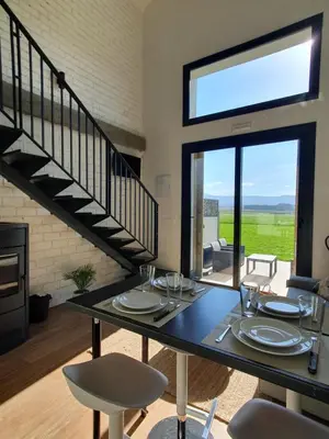 a dining room with a table and a staircase at Apartamentos Islas Pantorgas in Tapia de Casariego