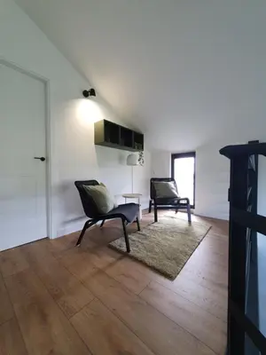 a living room with two chairs and a table at Apartamentos Islas Pantorgas in Tapia de Casariego