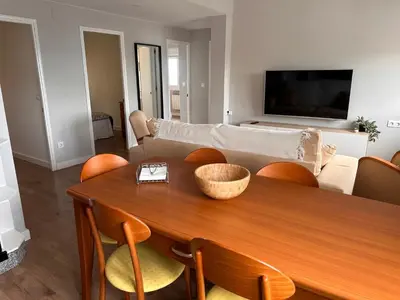 a living room with a table and a couch at Piso a pie de playa in Burela de Cabo