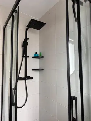 a shower with a glass door in a bathroom at Piso a pie de playa in Burela de Cabo