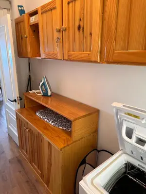 a small kitchen with wooden cabinets and a sink at Piso a pie de playa in Burela de Cabo