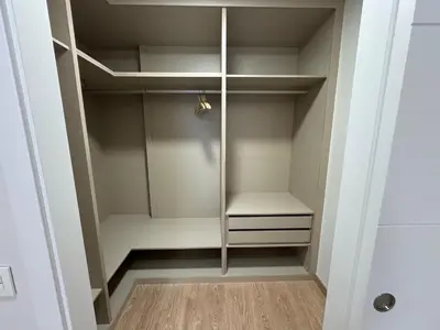 a walk in closet with white cabinets and a wooden floor at Neypa Liberdade in Sarria