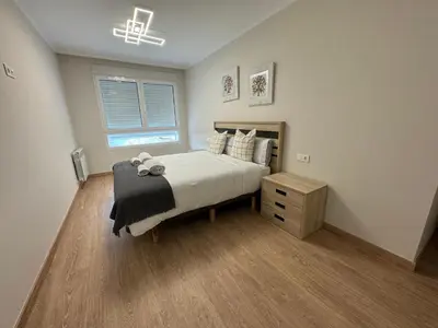 a bedroom with a bed and a dresser and a window at Neypa Liberdade in Sarria