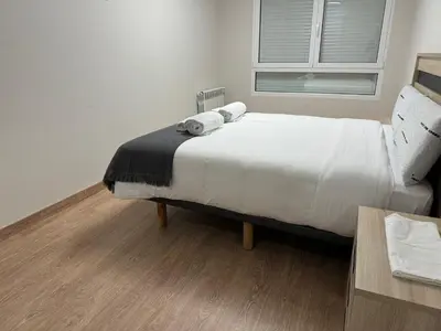 a bedroom with a bed with two towels on it at Neypa Liberdade in Sarria