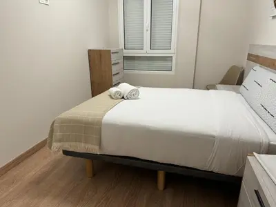 a bedroom with a bed with two towels on it at Neypa Liberdade in Sarria