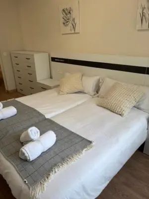 a large white bed with towels on top of it at Neypa Liberdade in Sarria