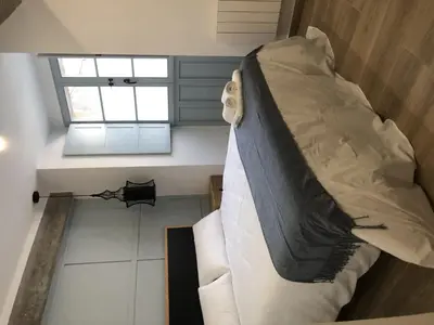 a large bed in a room with a window at CASA DO QUEIXEIRO in Castroverde
