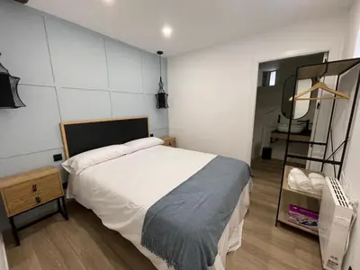a bedroom with a large bed and a mirror at Apartamento 04 in Castroverde