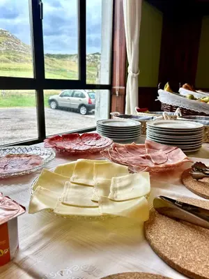 a table with plates of food on top of it at Coronel Somiedo by Unusual Hotels in El Puerto de Somiedo