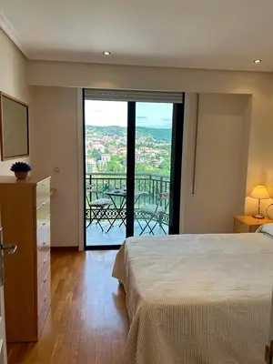 a bedroom with a bed and a view of a balcony at Vistas Miño in Ourense