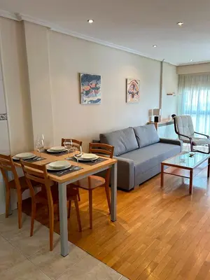 a living room with a table and a couch at Vistas Miño in Ourense