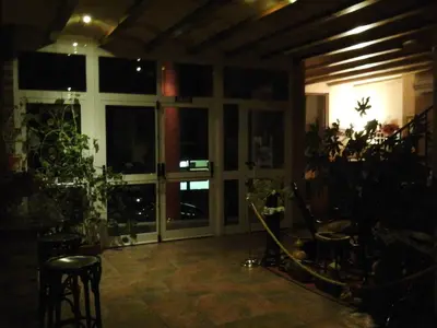 a living room with a large window and plants at Hostal Piñera in Vega de Espinareda