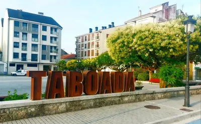 a sign that says taloudzin in a city at Taboada Sacra Home in Taboada