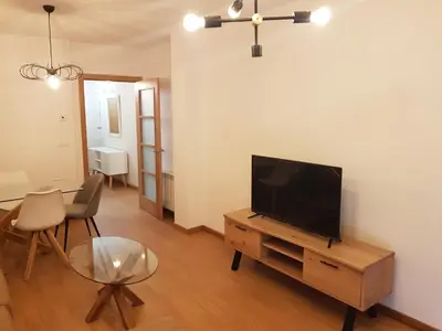 a living room with a flat screen tv on a wooden table at Taboada Sacra Home in Taboada