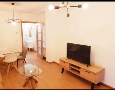 a living room with a flat screen tv on a wooden entertainment center at Taboada Sacra Home in Taboada