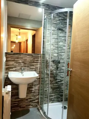 a bathroom with a sink and a shower at Taboada Sacra Home in Taboada