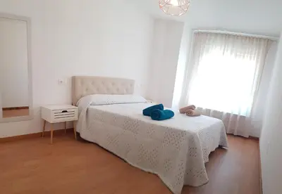 a bedroom with a bed with a blue towel on it at Taboada Sacra Home in Taboada