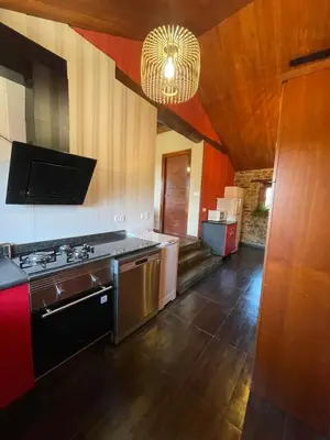 a kitchen with a sink and a stove top oven at Alojamiento bodega LOF in Valtuille de Abajo